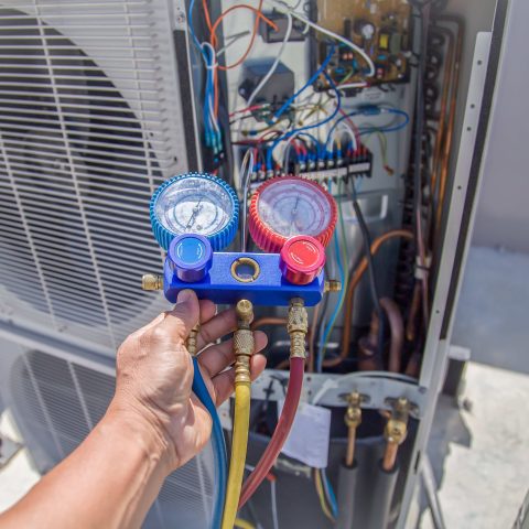 Hvac technician servicing a residential home's HVAC system in Ashburn, VA.