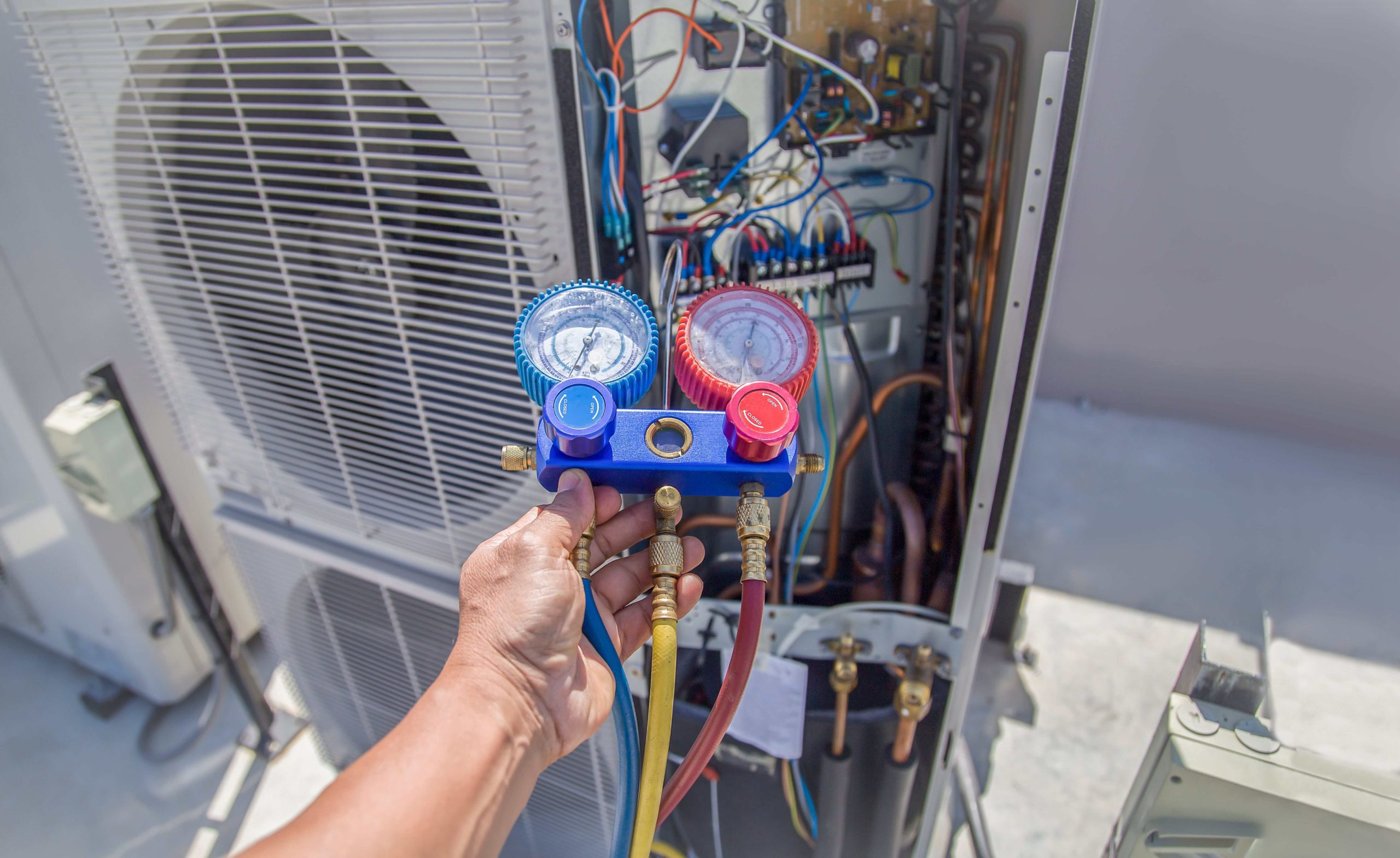 Hvac technician servicing a residential home's HVAC system in Ashburn, VA.