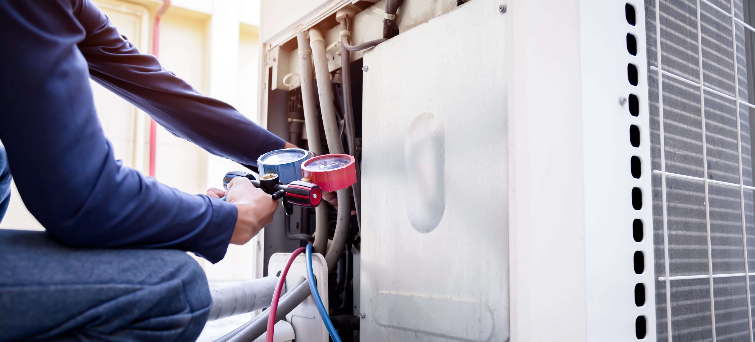 HVAC technician working on a residential HVAC unit in Leesburg, VA.