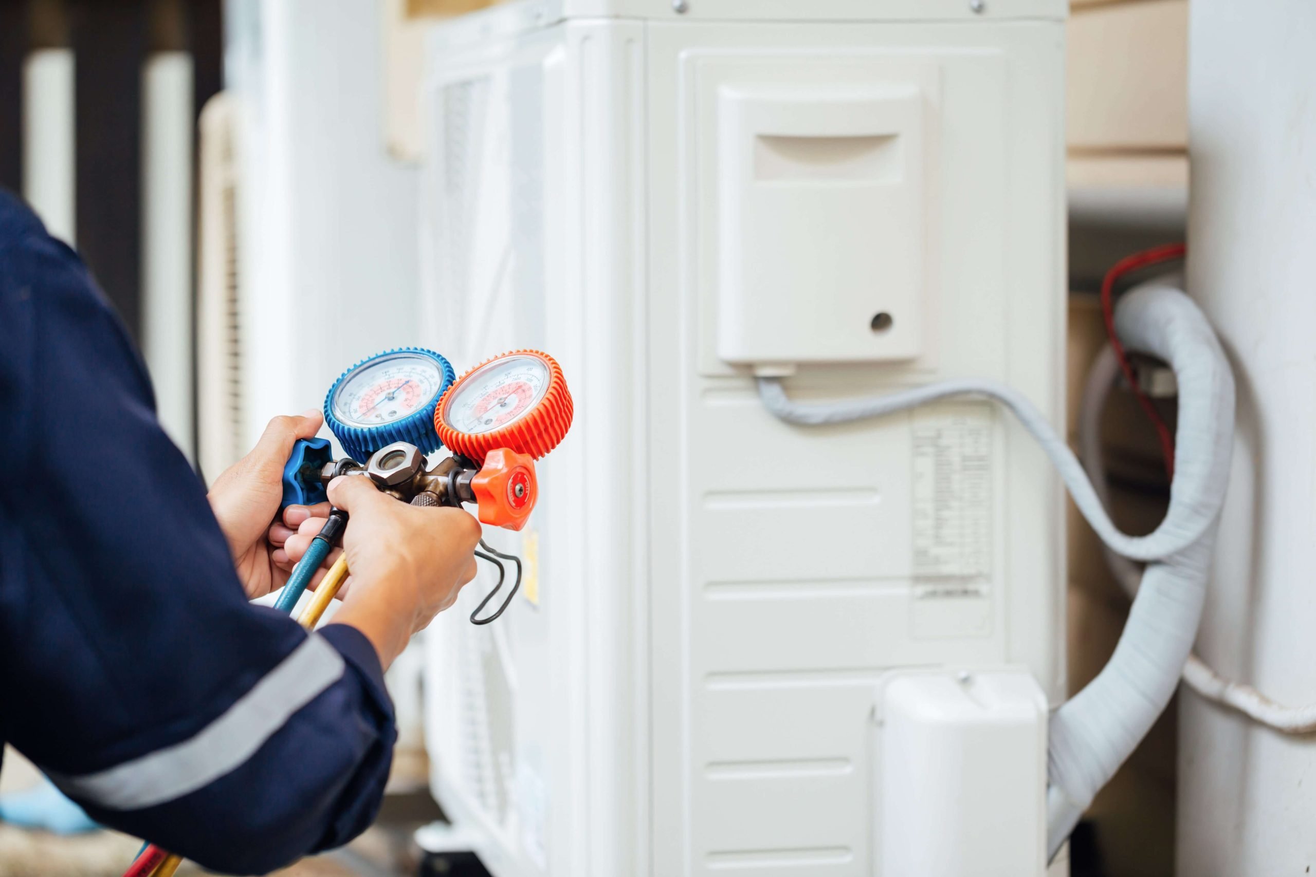 Hvac technician working on a residential HVAC system in Sterling, VA.
