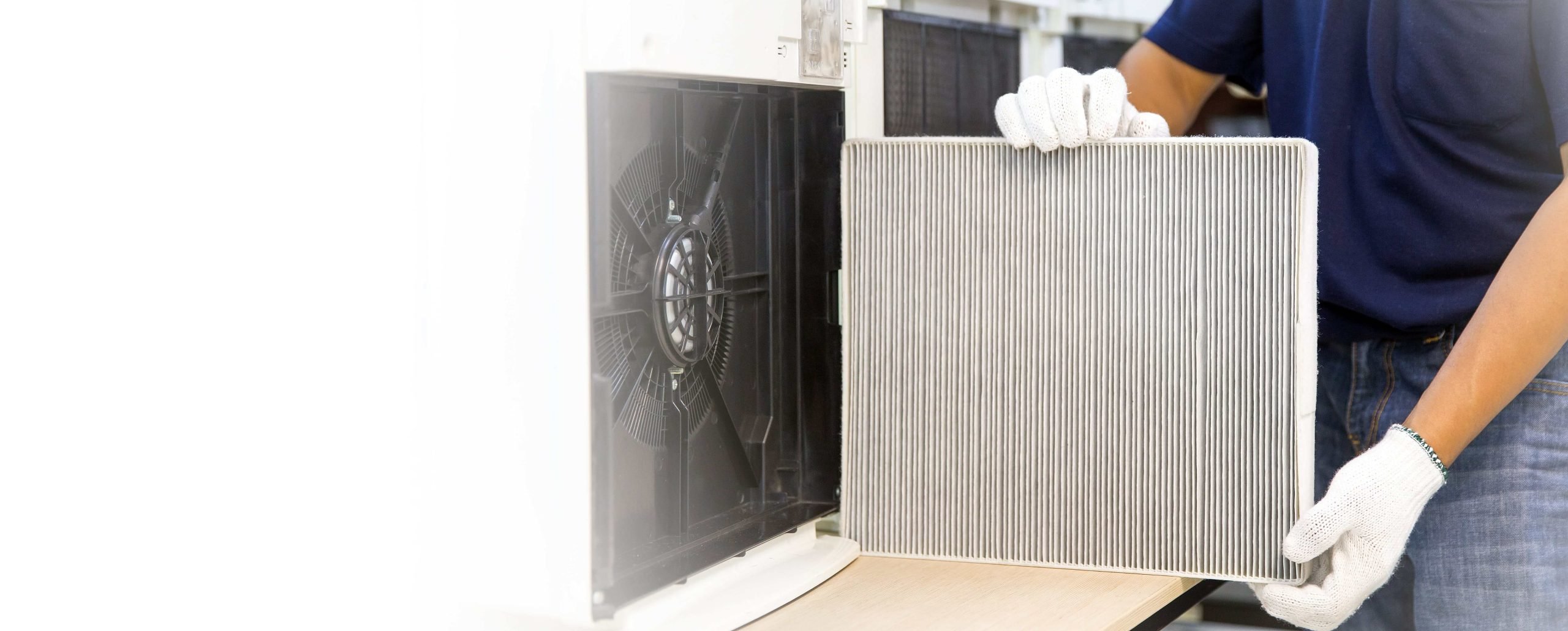 HVAC technician replacement a humidifier filter in a residential home